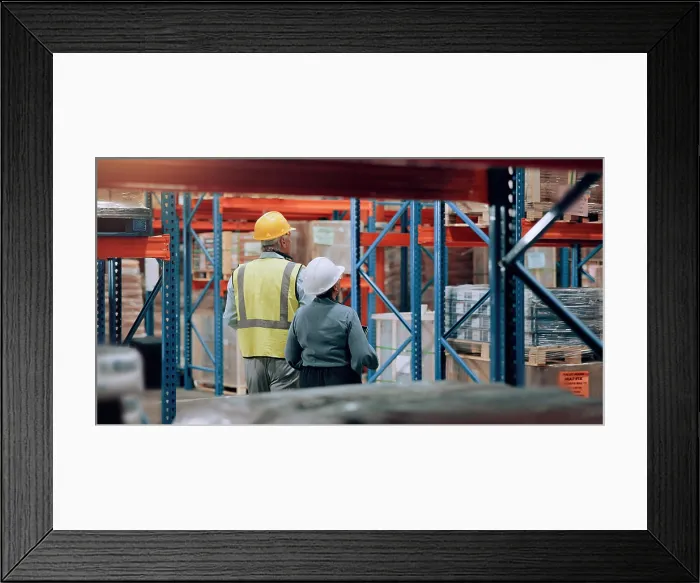 Framed Print : Distribution, man and woman walking in warehouse for logistics Framed Print : Distribution, man and woman walking in warehouse for logistics