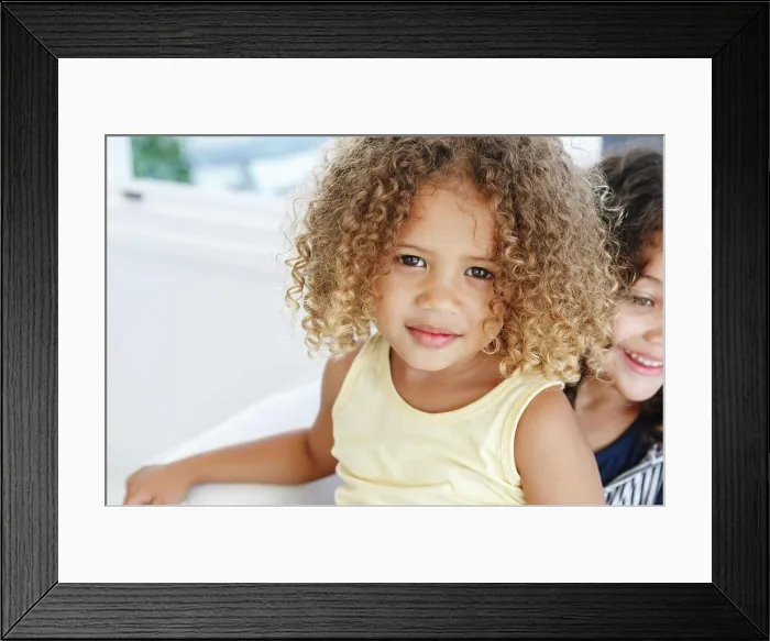Framed Print : Girl sitting on sister's lap at home Framed Print : Girl sitting on sister's lap at home