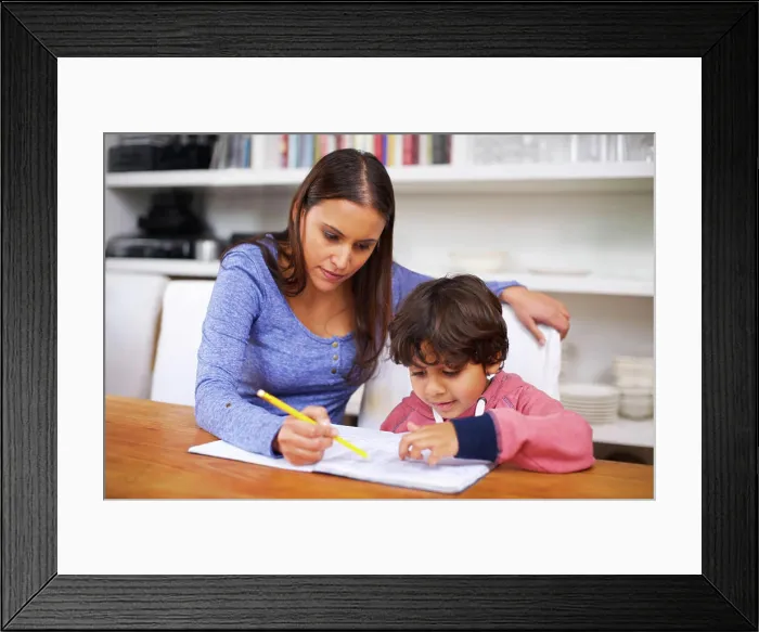 Framed Print : Mother, help and child with book for homework Framed Print : Mother, help and child with book for homework