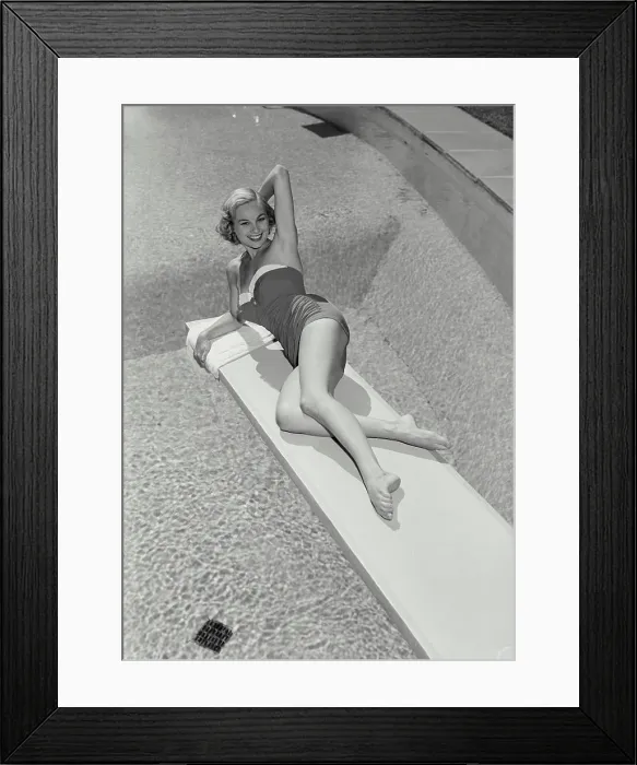 Framed Print : Vintage Photograph. Smiling blonde woman wearing bathing suit lying on diving board over swimming pool, Frame 1 Framed Print : Vintage Photograph. Smiling blonde woman wearing bathing suit lying on diving board over swimming pool, Frame 1