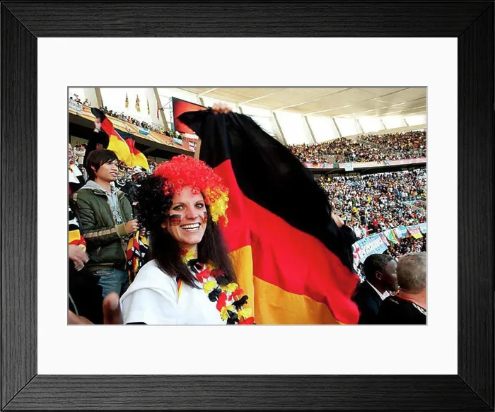 Framed Print : German football supporter with the German national flag in the stadium Framed Print : German football supporter with the German national flag in the stadium
