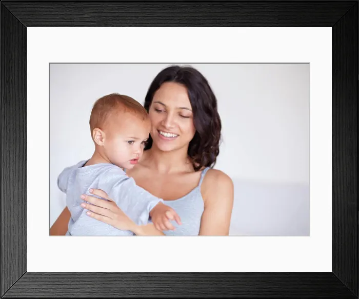 Framed Print : Mom holding toddler in home with smile