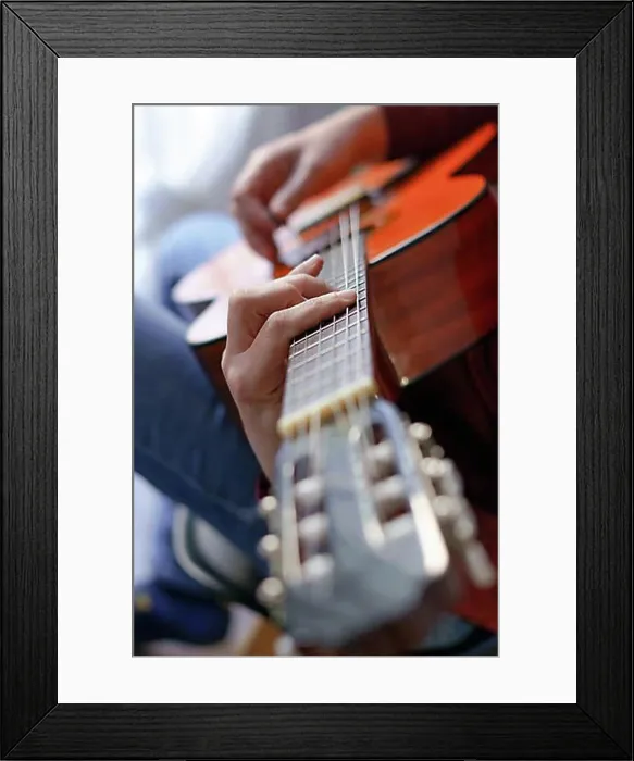 Framed Print : Close-up of a mans hands playing the spanish guitar selective approach