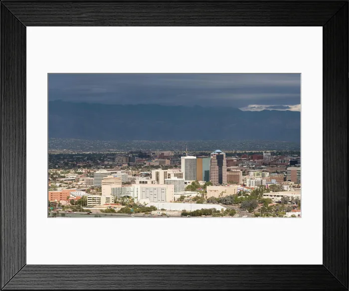 Framed Print : Downtown Tucson in Arizona with storm clouds Downtown area of Tucson in Arizona with the sun lighting the buildings