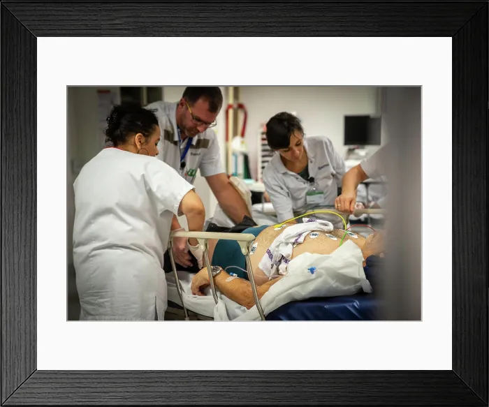 Framed Print : A patient who is not very lucid is placed under electrodes in intensive care to monitor his heart rate