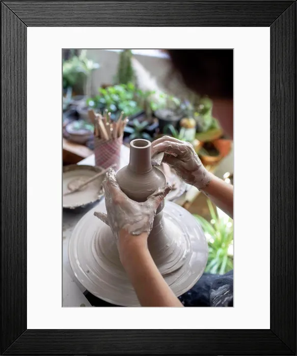 Framed Print : Backlit close-up of hands working on ceramic pot Framed Print : Backlit close-up of hands working on ceramic pot