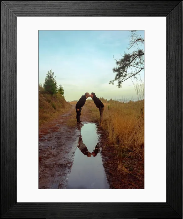 Framed Print : Water slop with reflection of homosexual couple embracing and kissing on road