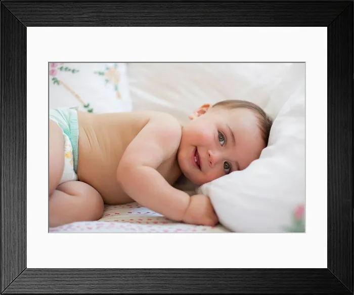 Framed Print : Baby boy laying on bed, London, UK Framed Print : Baby boy laying on bed, London, UK