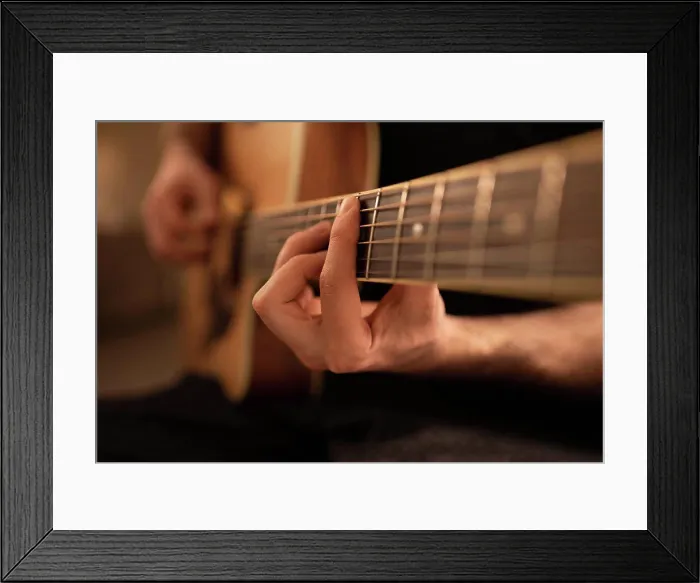Framed Print : Cropped man playing and tuning guitar Framed Print : Cropped man playing and tuning guitar