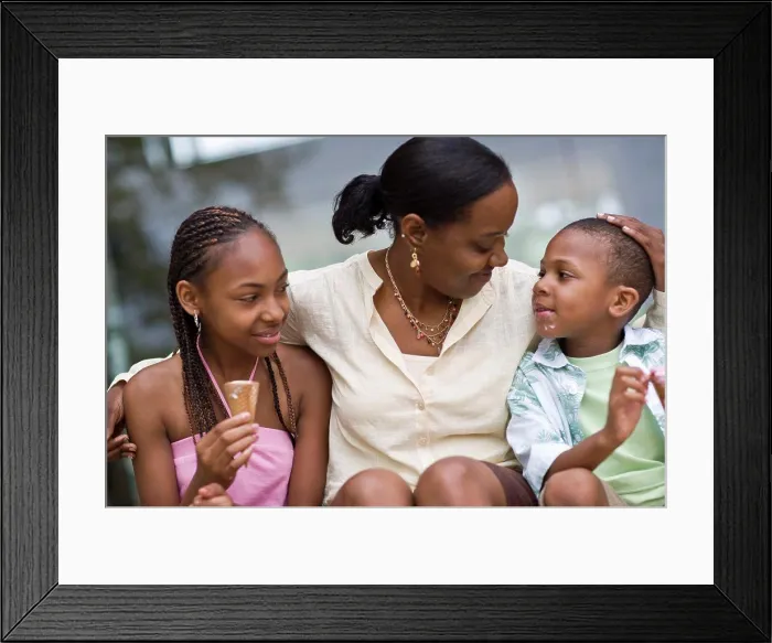 Framed Print : Smiling mother sitting with her arm around her daughter and son Framed Print : Smiling mother sitting with her arm around her daughter and son