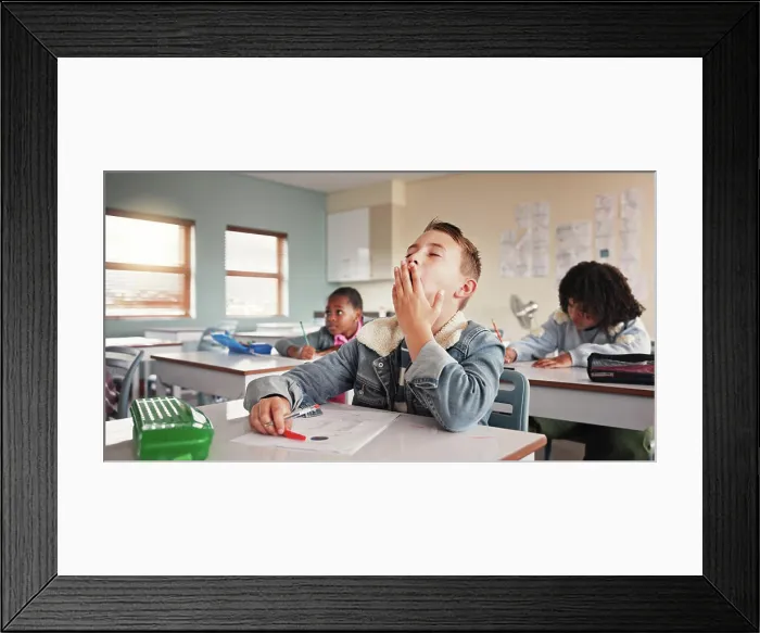 Framed Print : Tired, child and student in classroom for education lesson Framed Print : Tired, child and student in classroom for education lesson