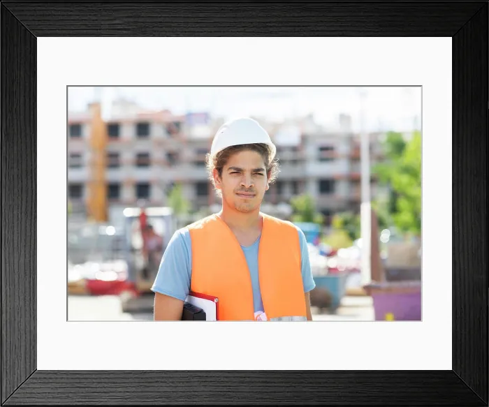 Framed Print : young construction engineer with helmet working outside Framed Print : young construction engineer with helmet working outside