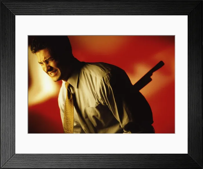 Framed Print : Side profile of a man stabbed in the back Framed Print : Side profile of a man stabbed in the back