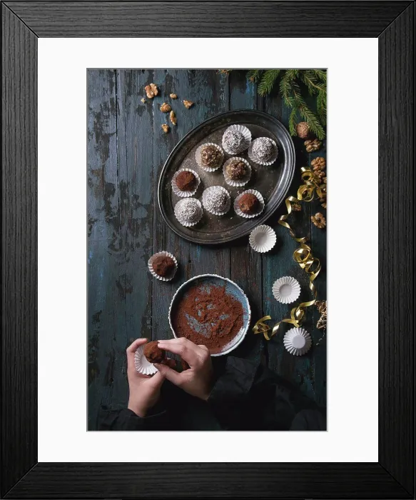Framed Print : Child hands make homemade dark chocolate truffles with cocoa powder
