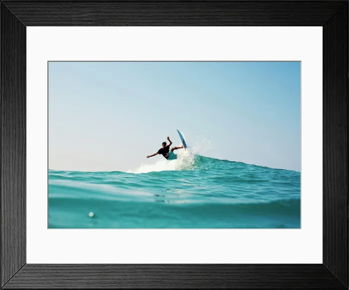 Framed Print : Male surfer riding turquoise blue ocean wave
