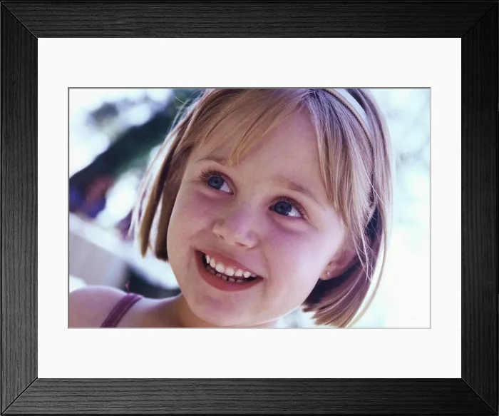 Framed Print : Close-up of a girl smiling Framed Print : Close-up of a girl smiling