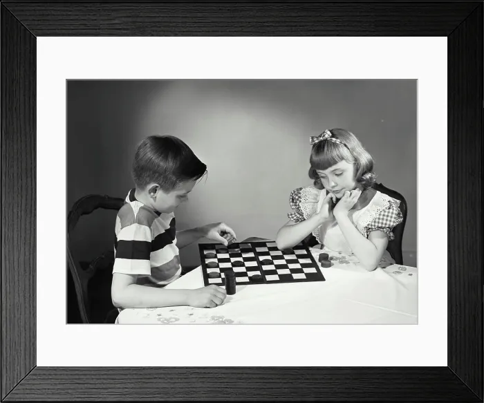 Framed Print : Vintage photograph. Children at table playing checkers Framed Print : Vintage photograph. Children at table playing checkers