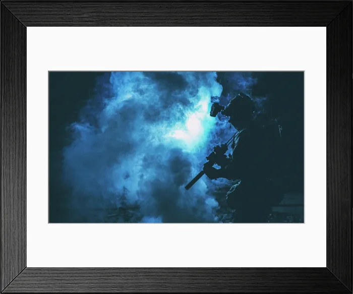 Framed Print : Silhouette of a soldier standing amongst smoke, armed with an assault rifle Framed Print : Silhouette of a soldier standing amongst smoke, armed with an assault rifle