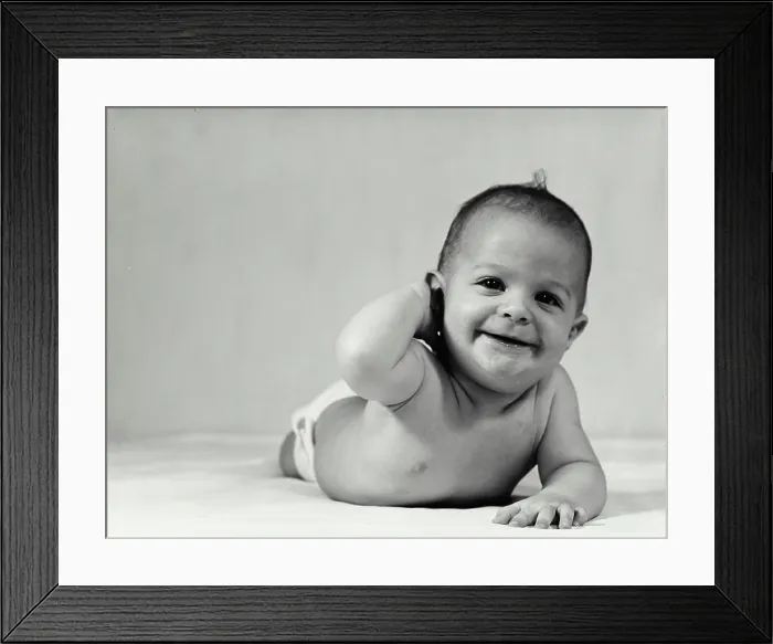 Framed Print : Vintage Photograph. Baby crawling with hand behind head smiling