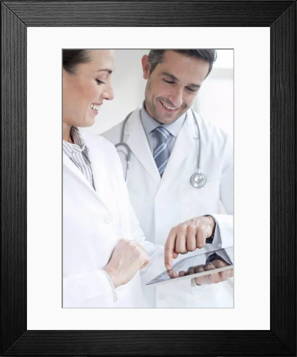 Framed Print : Male and female doctors using tablet Framed Print : Male and female doctors using tablet