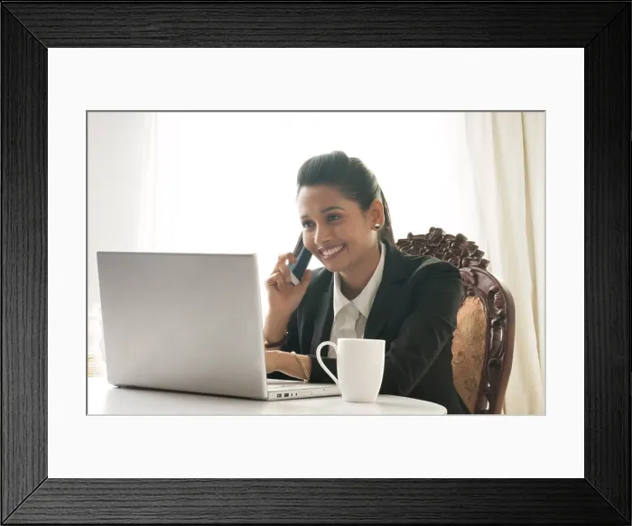 Framed Print : Business woman using mobile phone at desk Framed Print : Business woman using mobile phone at desk