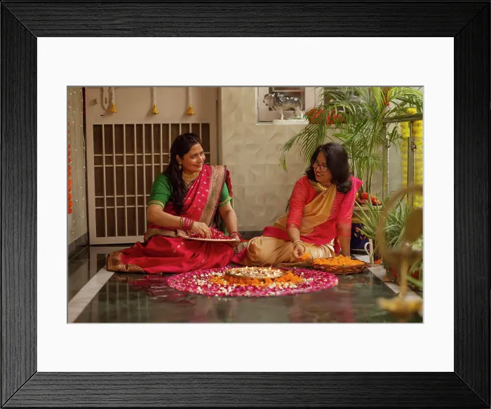Framed Print : Mother-in-law and daughter-in-law decorating house with lamps and flowers on the occasion of Diwali Framed Print : Mother-in-law and daughter-in-law decorating house with lamps and flowers on the occasion of Diwali