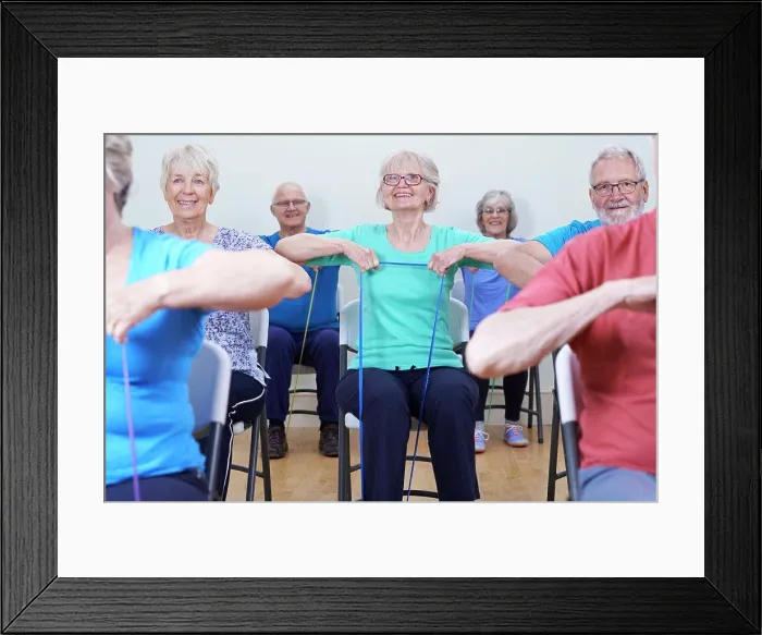 Framed Print : Group Of Seniors Using Resistance Bands In Fitness Class