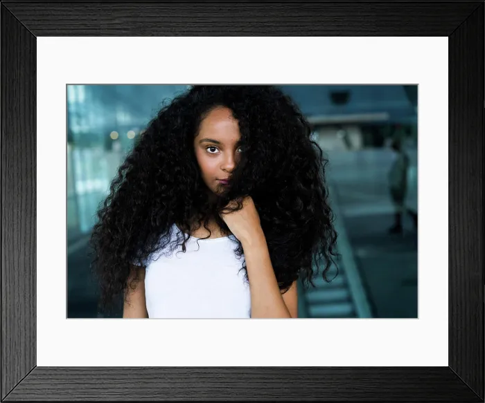 Framed Print : Pretty sensual African woman looking at camera in city mall Framed Print : Pretty sensual African woman looking at camera in city mall