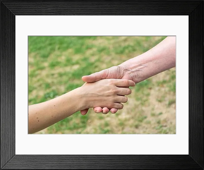 Framed Print : Old and young hands doing handshake Framed Print : Old and young hands doing handshake