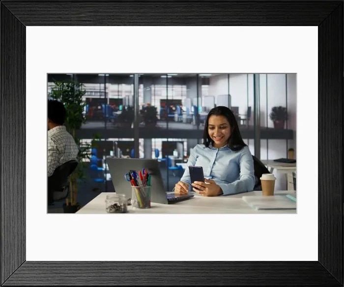 Framed Print : Indian employee engages in an online meeting with her team