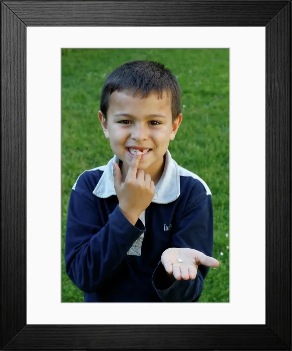 Framed Print : 7-year-old boy showing a missing tooth. France Framed Print : 7-year-old boy showing a missing tooth. France