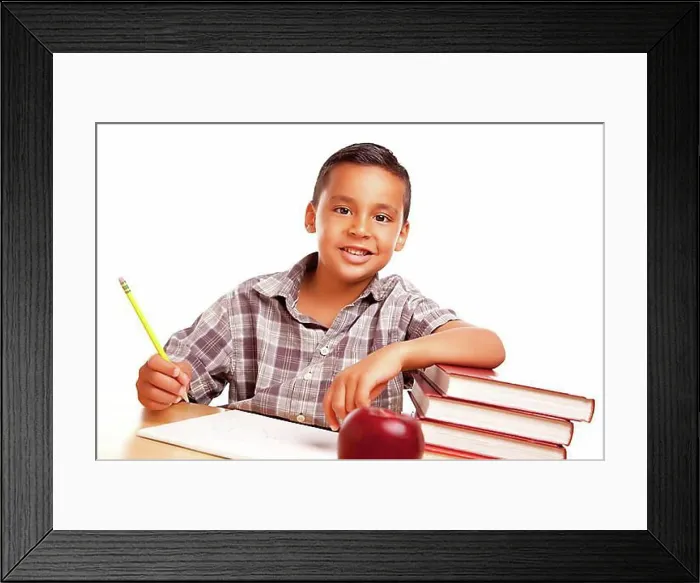 Framed Print : Adorable hispanic boy with books, apple, pencil and paper isolated on a white background Framed Print : Adorable hispanic boy with books, apple, pencil and paper isolated on a white background