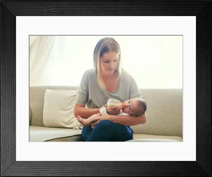 Framed Print : Mother, milk and feeding baby of sofa in living room for growth development