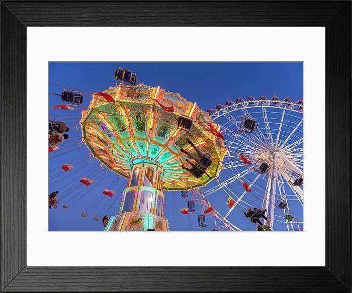 Framed Print : Illuminated carousel and Ferris wheel at night in a lively amusement park Framed Print : Illuminated carousel and Ferris wheel at night in a lively amusement park