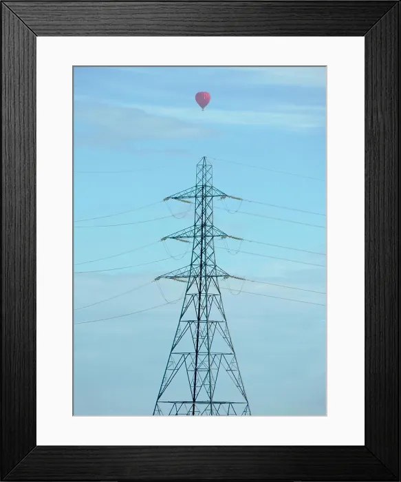 Framed Print : Line of pylons in a field outside Radley Village, with passing balloon Framed Print : Line of pylons in a field outside Radley Village, with passing balloon