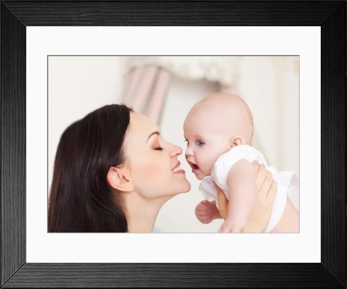 Framed Print : Happy smiling mother with six month old baby girl indoor Framed Print : Happy smiling mother with six month old baby girl indoor