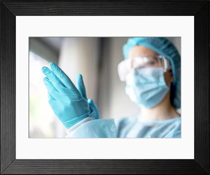Framed Print : Medicine and Surgery theme: doctor putting on protective blue gloves Framed Print : Medicine and Surgery theme: doctor putting on protective blue gloves