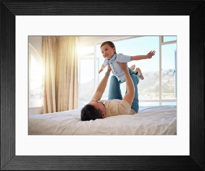 Framed Print : Father, boy and lifting game in home Framed Print : Father, boy and lifting game in home
