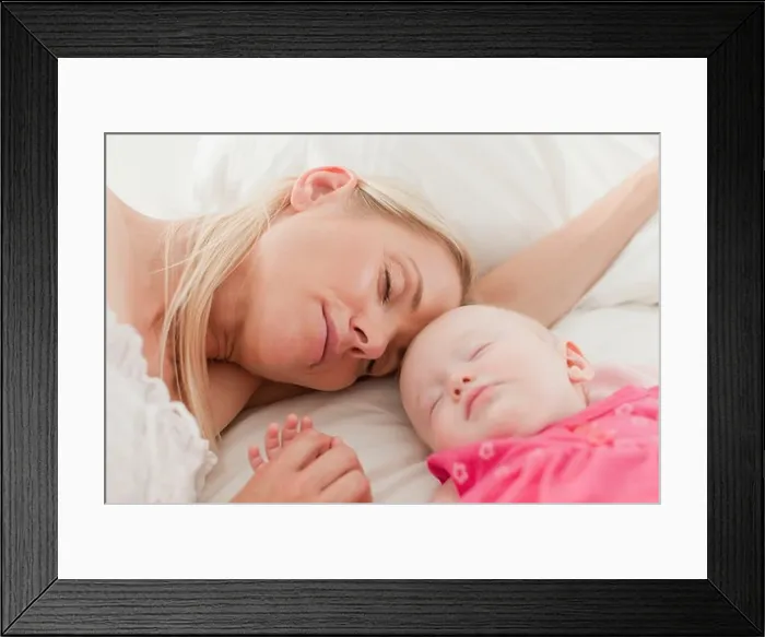 Framed Print : Mother and baby sleeping on bed