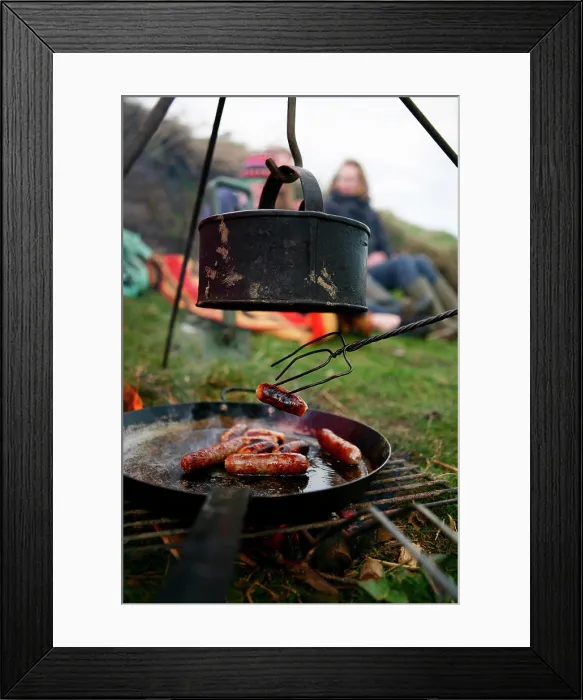 Framed Print : A family grills sausages and boils water on a camp fire near Ellingstring