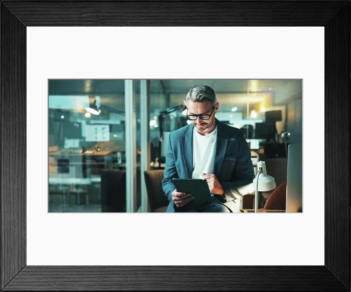 Framed Print : Mature programmer, tablet and review with project Framed Print : Mature programmer, tablet and review with project