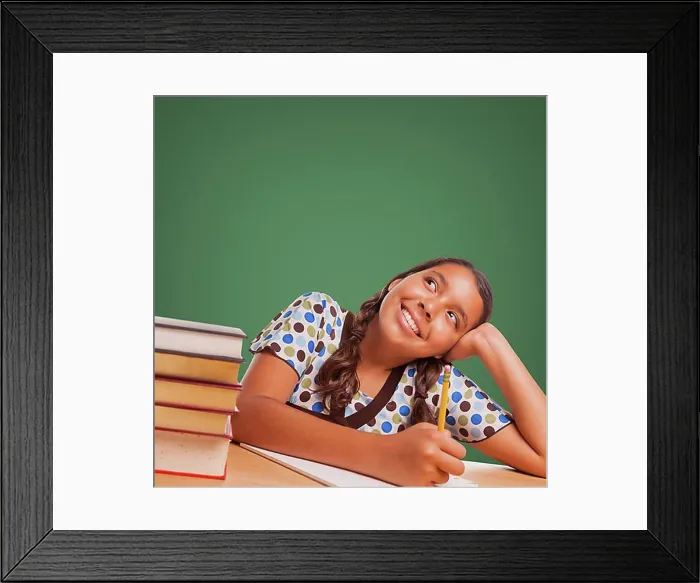 Framed Print : Cute hispanic girl studying and looking up to blank chalk board Framed Print : Cute hispanic girl studying and looking up to blank chalk board