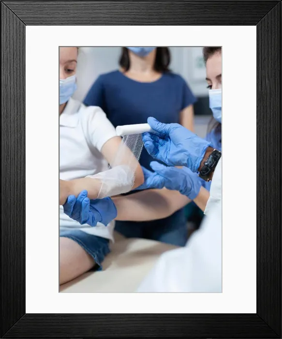 Framed Print : Closeup of african american pediatrician doctor bandage fractured broken arm
