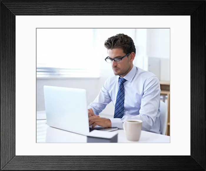 Framed Print : Businessman, laptop and typing in office for online communication as financial consultant