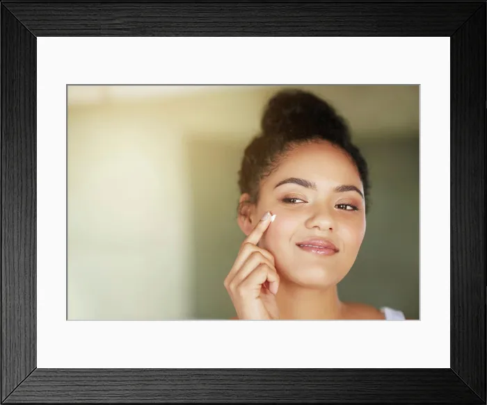 Framed Print : Skincare, beauty and happy woman with cream in bathroom for dermatology