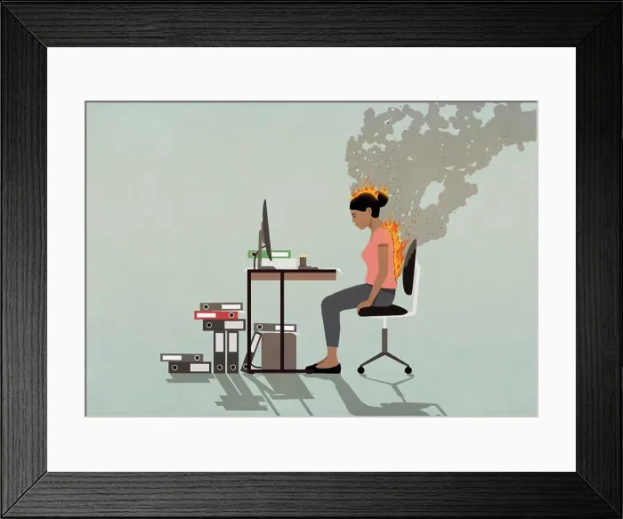 Framed Print : Businesswoman sitting at desk with back and head burning Framed Print : Businesswoman sitting at desk with back and head burning