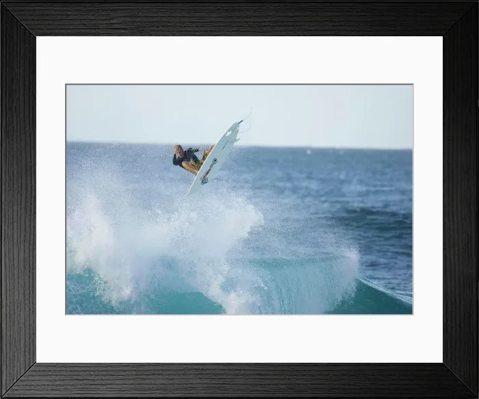 Framed Print : A young man surfing at Rocky Point, north shore