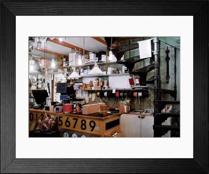 Framed Print : Illuminated pendant lights hanging over checkout counter against various equipment at hardware store Framed Print : Illuminated pendant lights hanging over checkout counter against various equipment at hardware store