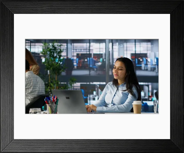 Framed Print : Indian businesswoman conducting a video call to review financial strategies with her colleagues