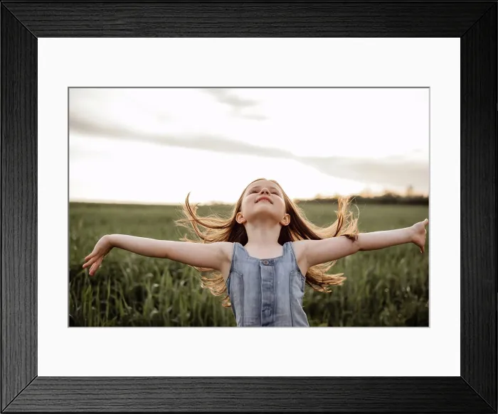Framed Print : Happy 5 years old girl in a green wheat field with long hair at sunset